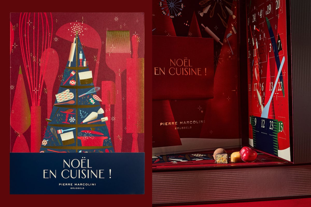 Calendrier de l'Avent Noël en Cuisine 2026 de Pierre Marcolini, avec son décor rouge illustré d'ustensiles de cuisine, ses cases numérotées et ses chocolats.