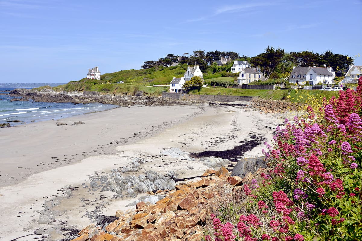 Plage de Locquirec avec rochers et végétation sur le littoral breton