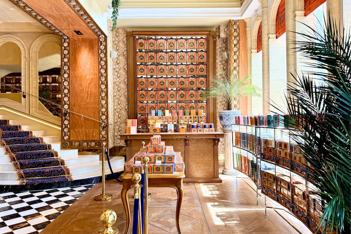 L’intérieur raffiné de Bacha Coffee sur les Champs-Élysées, avec escalier, boiseries, comptoirs de cafés et décor doré.
