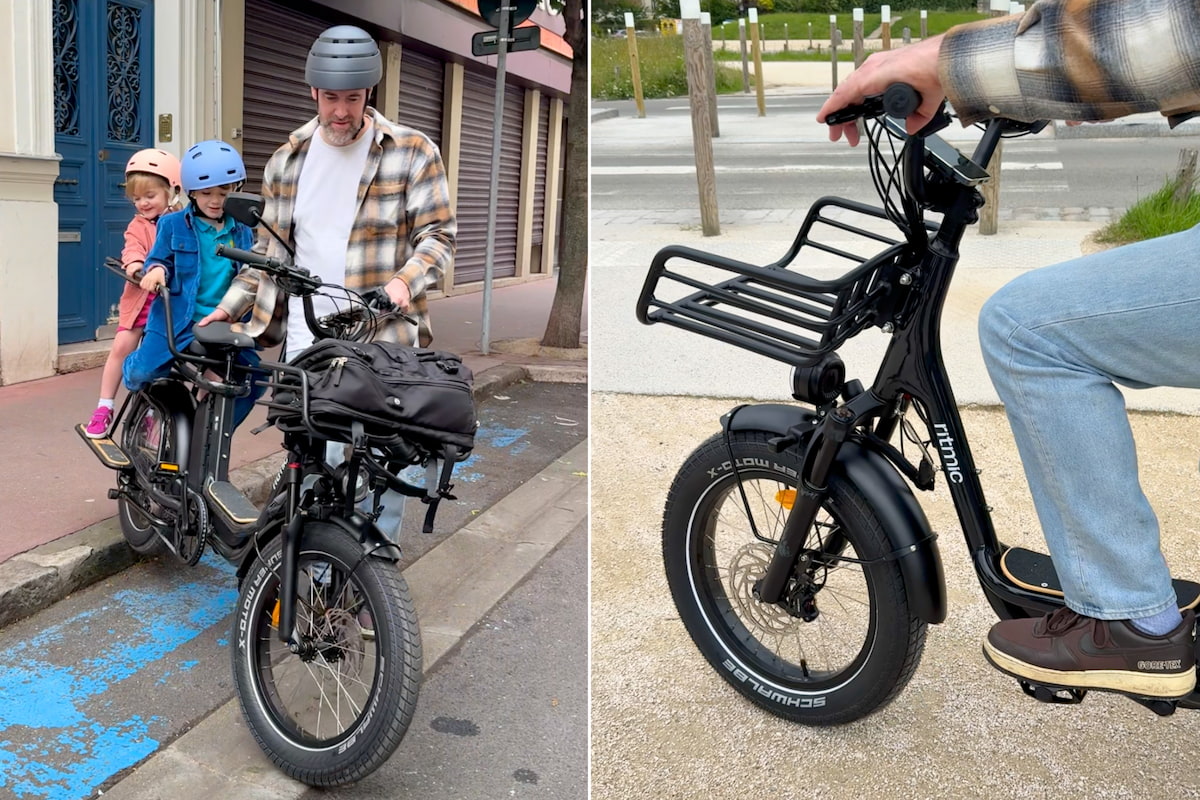 Un adulte se déplace en ville avec deux enfants sur un vélo cargo Ritmic Jumbo, pratique pour les sorties en famille.